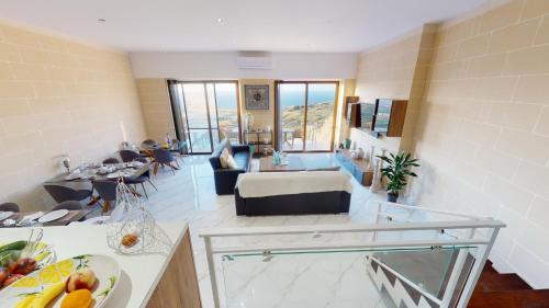 a living room with a bed and a living room at Dubhlina - Luxury Bed & Breakfast - Gozo in Żebbuġ