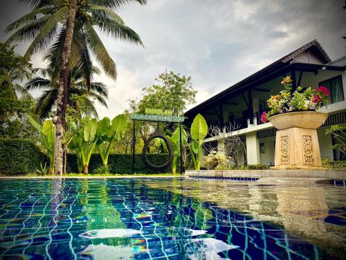 a swimming pool in front of a building at Palm Galleria Resort in Khao Lak