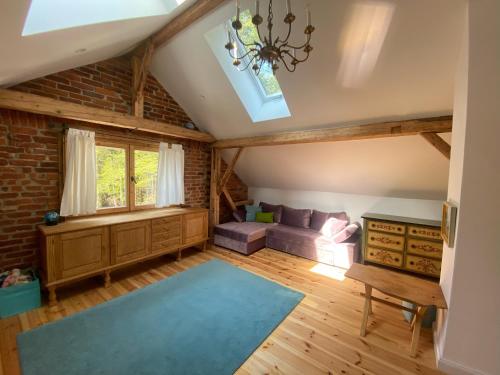 a living room with a couch and a table at Das Hexenhaus: Haus im Wald in Rinchnach