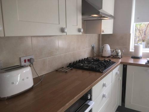 a kitchen with a stove and a counter top at The Marches, Ludlow in Ludlow