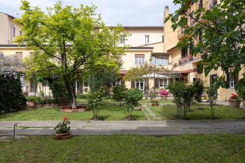 a garden in front of a large building at Antica Dimora Sant'Anna in Florence