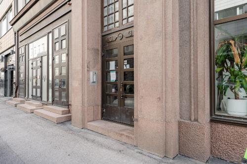 a row of windows on a building on a street at "Tuulensuu" - Historical 2BR Apartment with Sauna & Great Location, Hosted by 2ndhomes in Tampere