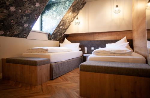 two twin beds in a room with a window at Bayerischer Hof in Ingolstadt