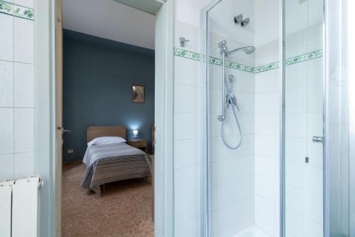 a bathroom with a shower and a bed in a room at Antica Dimora Sant'Anna in Florence
