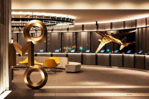 a rendering of a lobby with a giraffe statue at OMO Kansai Airport by Hoshino Resorts in Izumi-Sano