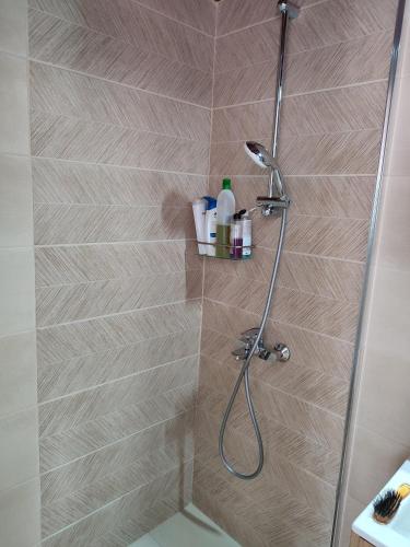 a bathroom with a shower with a glass door at Perseids Traditional House in Amorgos
