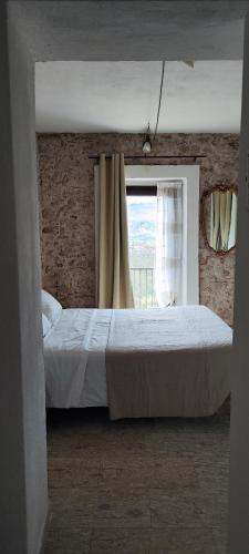 a bedroom with a large bed and a window at Il Querceto Delle Marine in LʼAquila