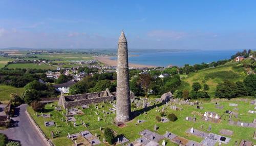 an aerial view of the ruins of a tower in a cemetery at Hillside in Ardmore