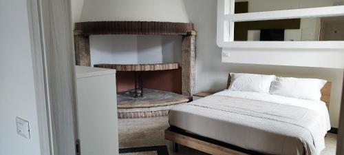 a bedroom with a bed and a fire place at Il Querceto Delle Marine in LʼAquila