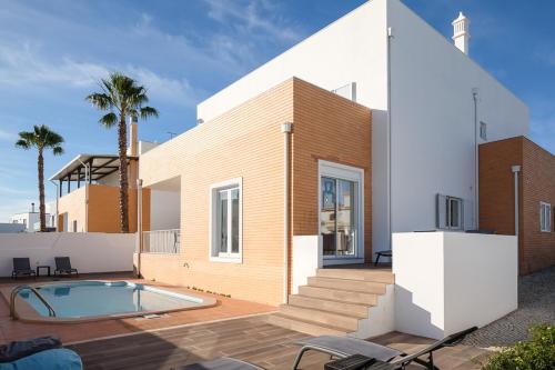 ein Haus mit Pool davor in der Unterkunft Casa Chlodette - luxury villa, 5 bedroom, private pool in Fuseta