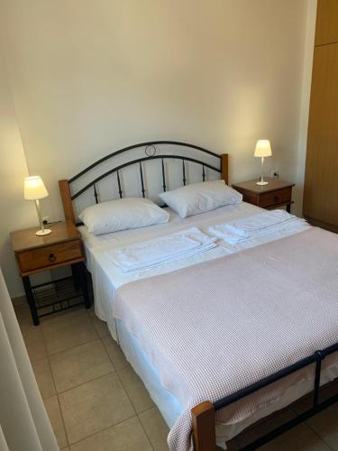 a bedroom with a large bed with two night stands at κοχύλι 1 in Armenistis