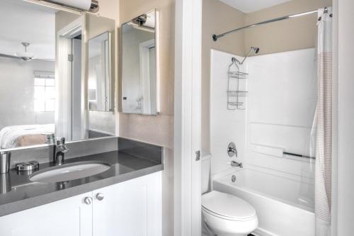 a white bathroom with a sink and a toilet at La Jolla 1br w gym wd pool nr bars shops SAN-7 in San Diego