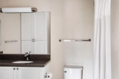 a bathroom with a sink and a toilet and a mirror at La Jolla 2br w gym wd pool nr bars shops SAN-21 in San Diego