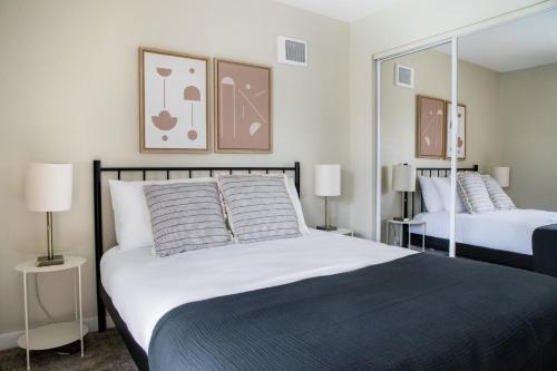 a bedroom with two beds with mirrors and lamps at La Jolla 2br w gym wd pool nr bars shops SAN-21 in San Diego