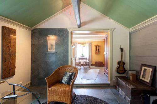 een woonkamer met een stoel en een gitaar bij Torppa Stengård 1700-luvulta in Porvoo