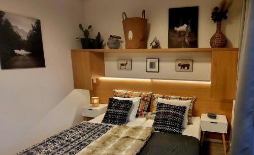 a bedroom with a bed with pillows on it at Loft Rezidence Vista in Rokytnice nad Jizerou
