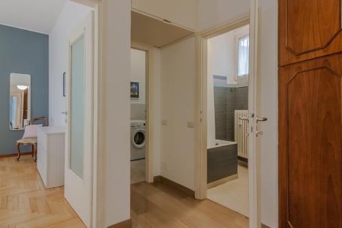 a bathroom with a sink and a washing machine at Como Borghi Apartment by Wonderful Italy in Como