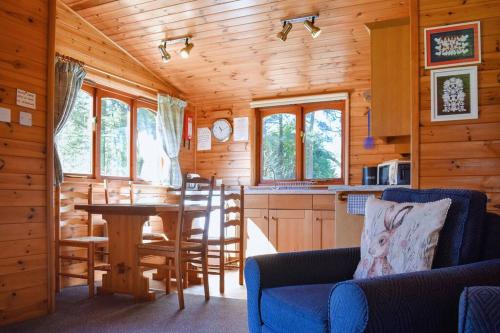 a kitchen and dining room of a log cabin at Secluded Pine Lodge 1 in Carlisle