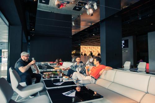 a group of people sitting on couches in a room at Zonar Zagreb by Maistra City Vibes in Zagreb