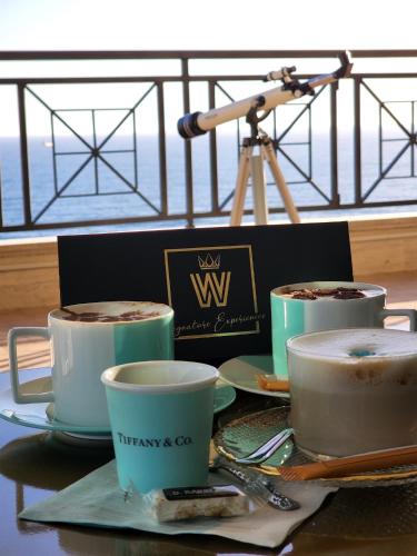 three cups of coffee on a table with a camera at B&B Seataly by W Signature Experiences in Civitavecchia