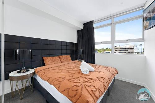 a bedroom with a large bed and a window at Aircabin - Chatswood - Walk to station - 2 Beds Apt in Sydney