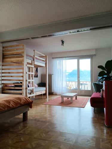 a bedroom with two bunk beds and a balcony at La plus belle vue du lac Léman in Montreux