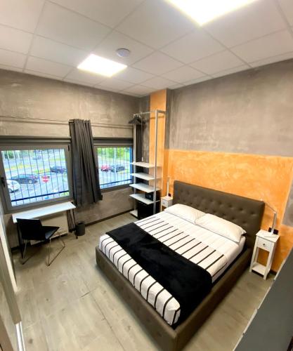 a bedroom with a bed and a desk in it at HOTEL TECH in Brembate