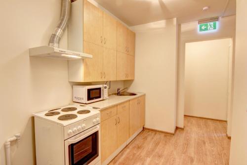 a kitchen with a stove and a microwave at Oginskio st 5 Vilnius Students Home LT in Vilnius