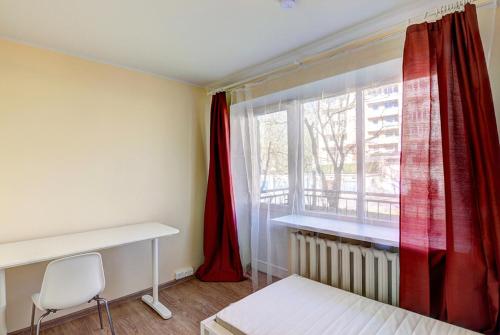 a bedroom with a bed and a window with red curtains at Oginskio st 5 Vilnius Students Home LT in Vilnius