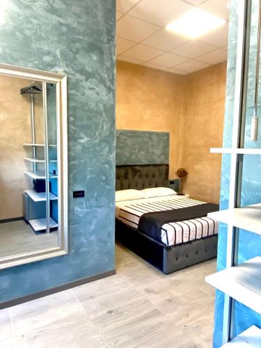 a bedroom with a bed and a mirror at HOTEL TECH in Brembate
