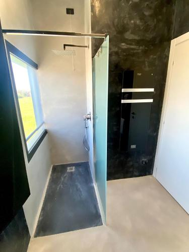 a bathroom with a shower with a glass door at HOTEL TECH in Brembate