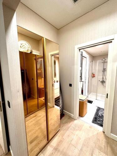 a room with a bathroom with a shower and a glass door at Skyland İstanbul + 42 plus in Istanbul