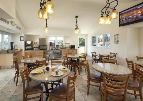 a restaurant with tables and chairs and a kitchen at Sandpiper Lodge - Santa Barbara in Santa Barbara