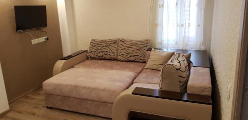 a small living room with a couch and a table at Hakobyan's Home in Gyumri