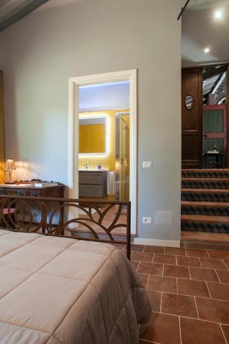 a bedroom with a bed and a table and stairs at La Giribaldina Winery & Farmhouse in Calamandrana