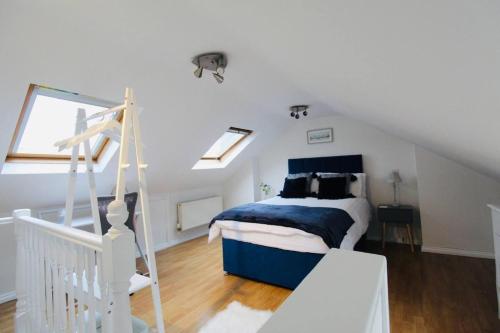 a bedroom with a bed and a staircase in a attic at Remarkable 3-Bed House in Bath in Bath