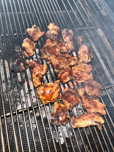 a bunch of chicken and other food on a grill at FernHills Homestay in Madikeri