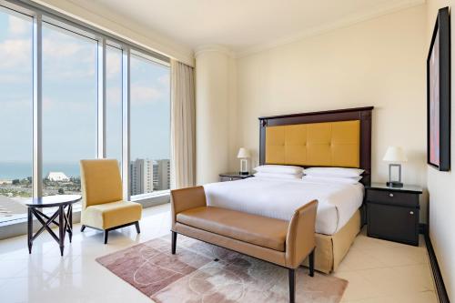 a bedroom with a bed and a desk and a chair at Marriott Marquis City Center Doha Hotel in Doha