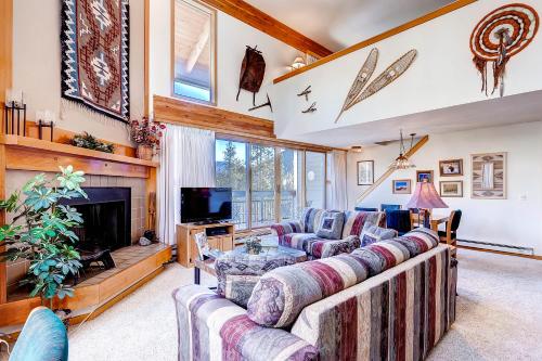 a living room with two couches and a fireplace at Evergreen Condominiums by Keystone Resort in Keystone
