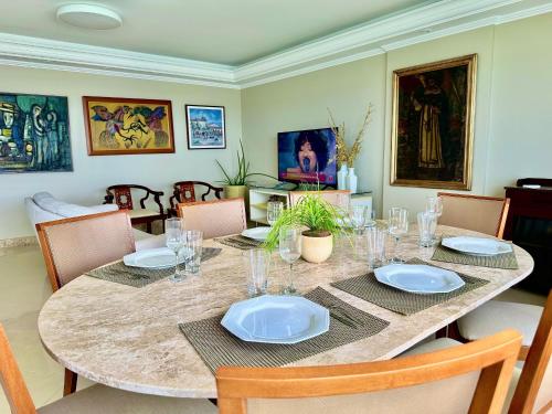 a dining room table with plates and glasses on it at Ondina Apart Hotel Residences in Salvador