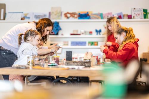 a group of people sitting at a table with a child at Berghaus Schröcken - Hotel Apartments Spa in Schröcken
