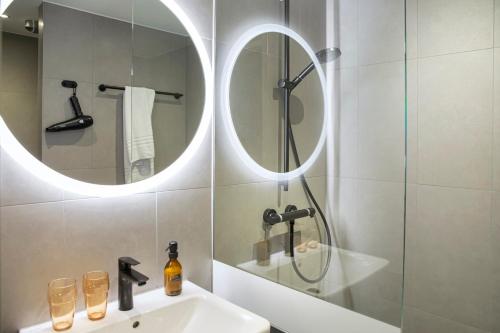 a bathroom with a sink and a mirror at LOGINN Hotel Waiblingen in Waiblingen