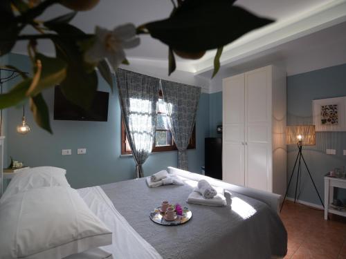 a bedroom with a bed with a plate of food on it at Locanda dei Sette Limoni - camere e residence in Vada