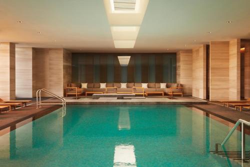 a swimming pool in a hotel room with furniture at Four Seasons Hotel Toronto at Yorkville in Toronto