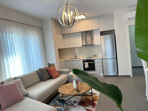 a living room with a couch and a table at Mozart House - Spacious Luxury Apartment - Heart of the City in Tirana