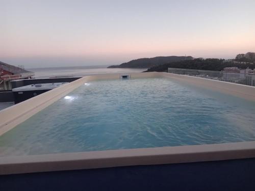 a swimming pool on the roof of a building at Onebedroom apartment with a pool and jacuzzy in Budva