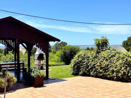 a pavilion in a garden with a bush at Tavira Vila Formosa 3 With Pool by Homing in Tavira