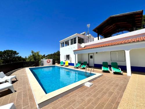 a swimming pool in front of a house at Tavira Vila Formosa 1 With Pool by Homing in Tavira