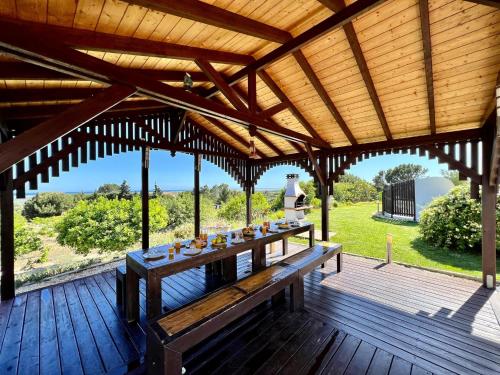a wooden deck with a table with drinks on it at Tavira Vila Formosa 1 With Pool by Homing in Tavira