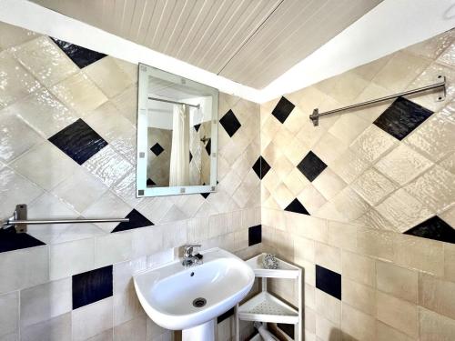 a bathroom with a sink and a mirror at Tavira Vila Formosa 6 With Pool by Homing in Tavira